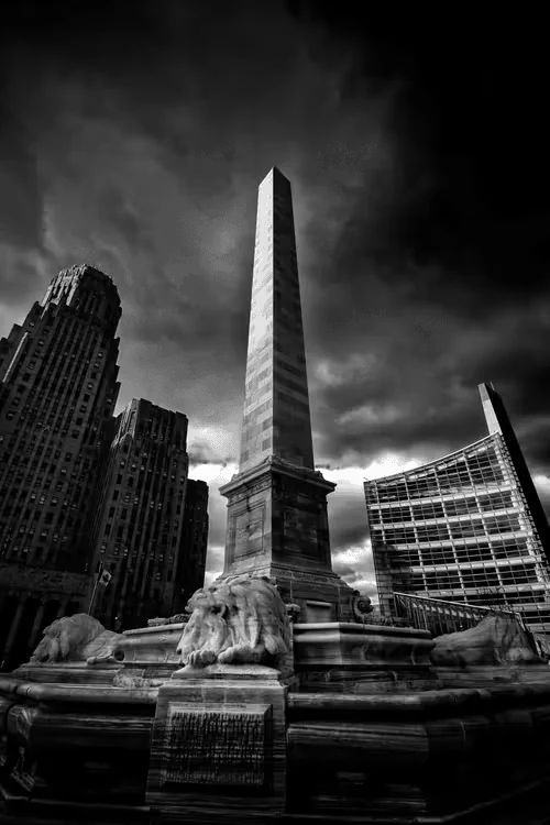 Bright Darkness collection artwork: black-and-white monument beneath dramatic clouds